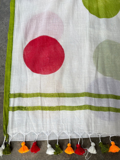 mul cotton saree with colorful polka dots and tassels on a gray surface