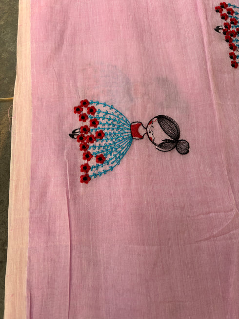 Pink mul saree with embroidered design of a girl in a blue dress by Taana Bana